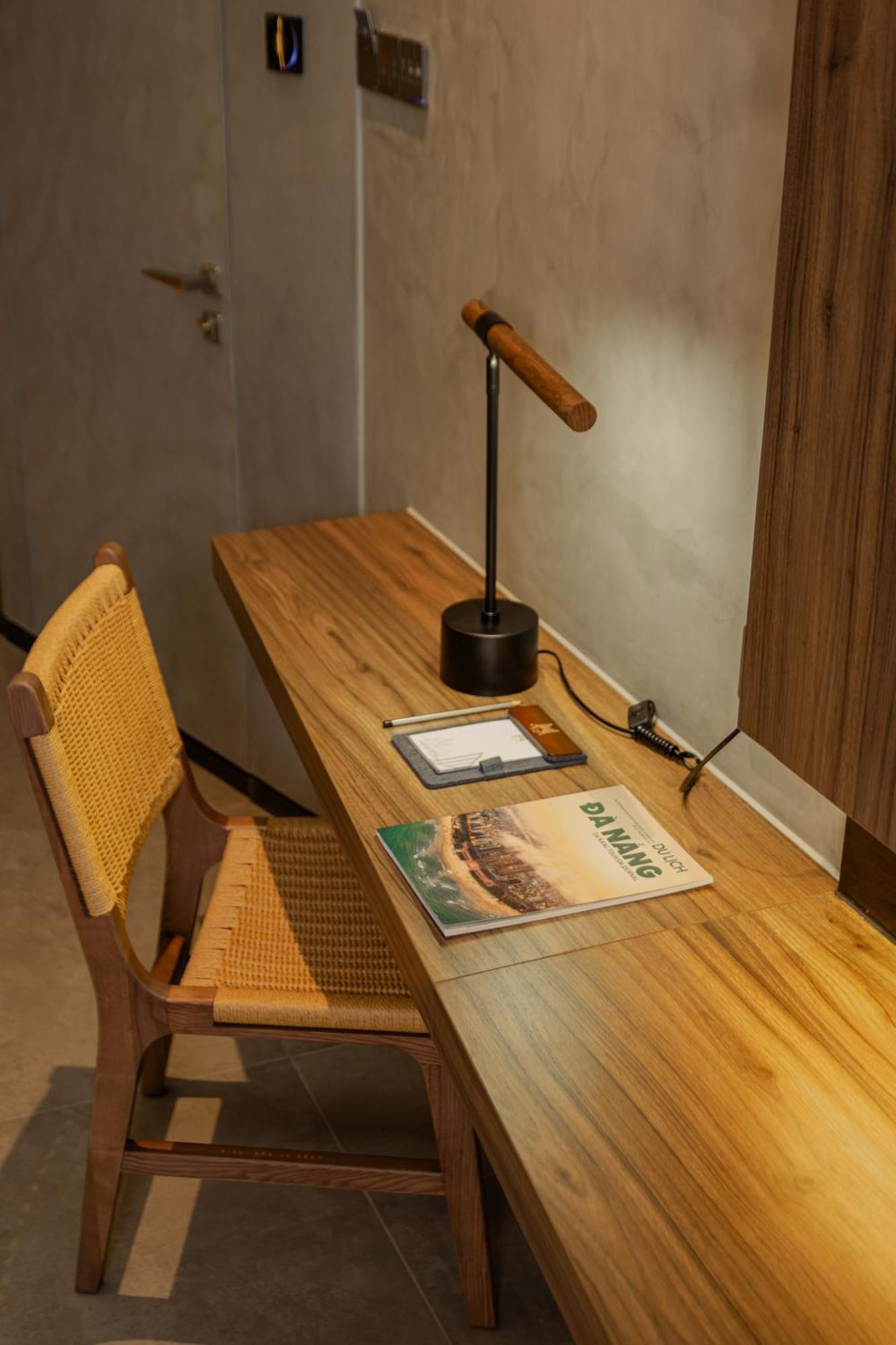 M Hotel Danang Esterno foto A desk with a magazine on it